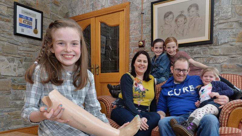Amy Sheridan (11) who was born without a fibula, the long, thin bone in the lower leg that runs parallel to the tibia, at home in Dunleer, Co Louth with her mother Caitríona, father Shay and sisters Sally (7), Lucy (9) and Kelly (4). Photograph: Alan Betson