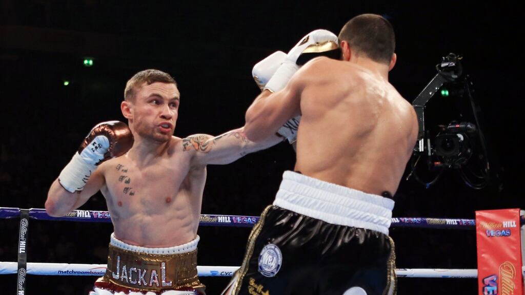 Carl Frampton lands a jab on Scott Quigg during their IBF & WBA World Super-Bantamweight Championship bout at Manchester Arena. Photo: Nick Potts/PA Wire.