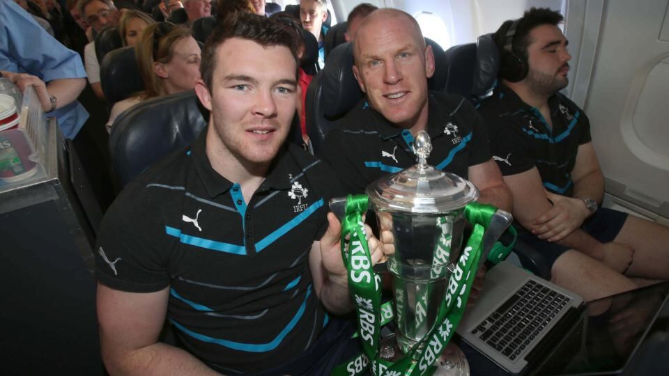 Peter O’Mahony and Paul O’Connell with the trophy on the plane on theway from Paris. Photograph: Dan Sheridan/Inpho