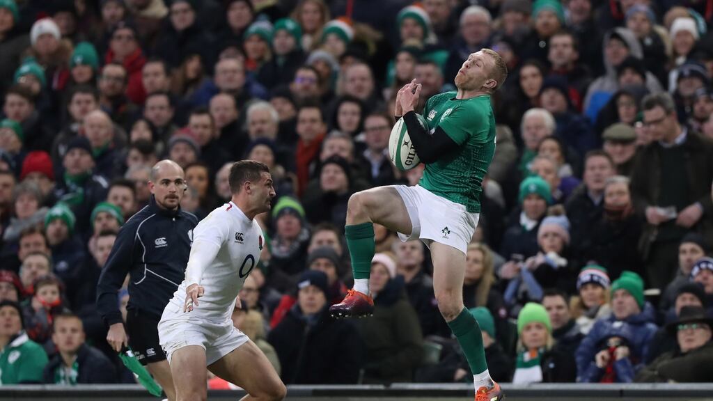 Keith Earls fields the ball ahead of England’s Jonny May. Photograph: Billy Stickland/Inpho