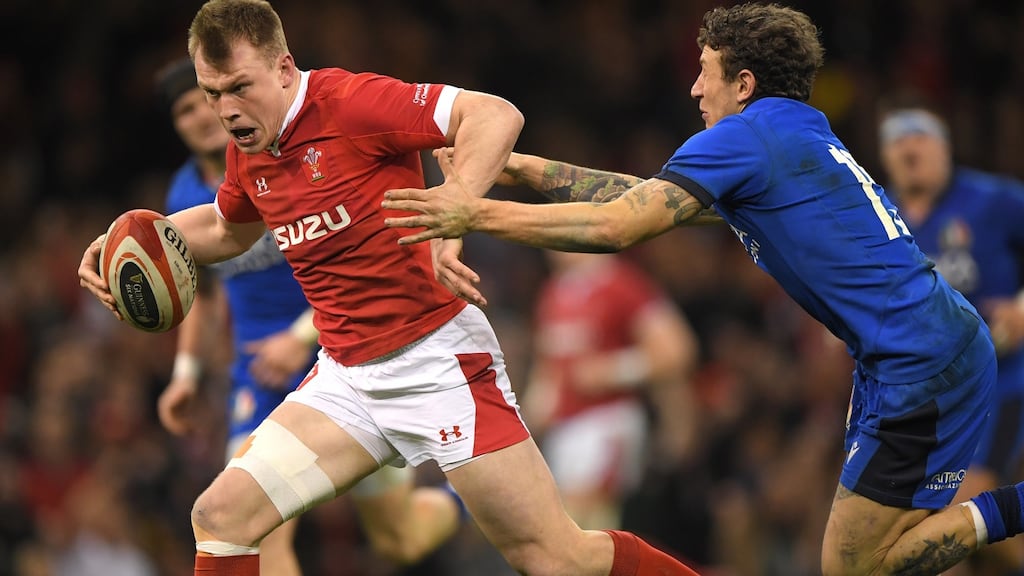 Nick Tompkins of Wales breaking past Italy fullback Matteo Minozzi to score a try during their Six Nations match in Cardiff. Photograph: , Stu Forster/Getty Images