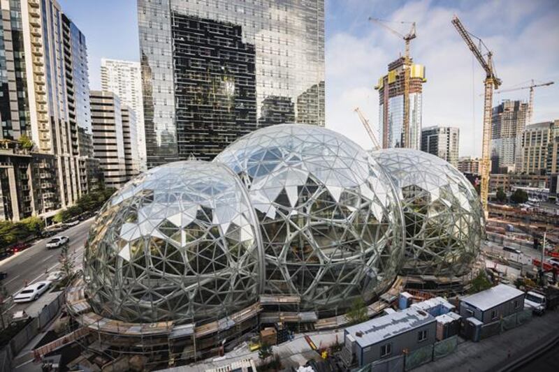 Amazon Tower II rises above the Amazon Biospheres in Seattle. Photograph: New York Times