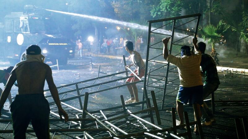 Police use water canon during clashes with protesters opposing an approved proposed constitutional amendment that would allow the election of a president to a second term, in Asuncion, Paraguay, on Friday. Photograph: Jorge Saenz/AP