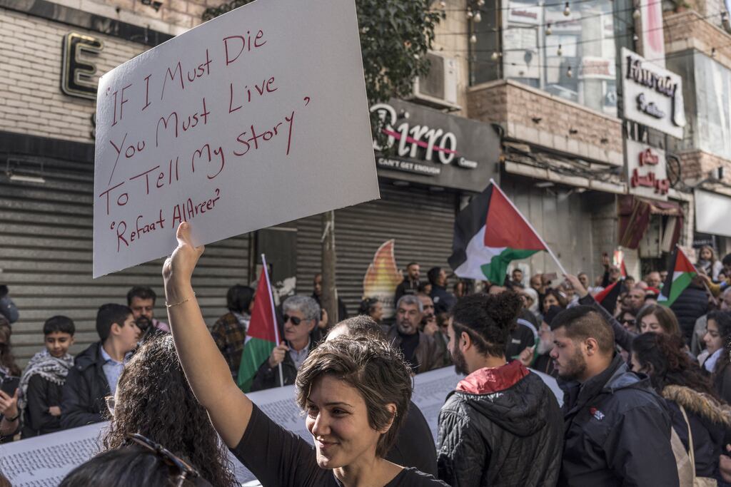 A woman carries a placard bearing lines by poet Refaat Alareer, who was killed in Gaza on December 7th, during a rally in Ramallah in the occupied West Bank on December 11th. Photograph: Marco Longari/AFP/Getty