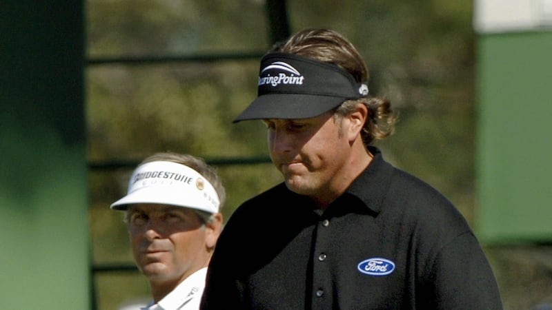 Phil Mickelson makes a birdie putt on the seveth hole in 2006 as Fred Couples looks on. Photograph: Stan Honda/Getty/AFP