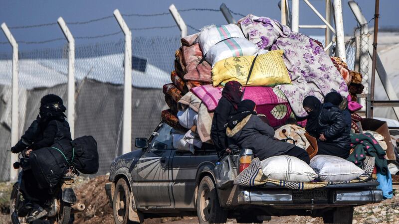 Women and children ride in the back of a truck loaded with  belongings, as they pass through the town of Jindayris, near the Syrian-Turkish border, at the weekend. Photograph: Rami al Sayed/AFP via Getty Images
