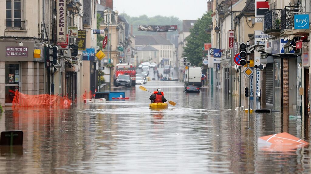 Residents use a canoe in downtown Nemours, France, after major flooding. Photograph: Francois Mori/AP Photo