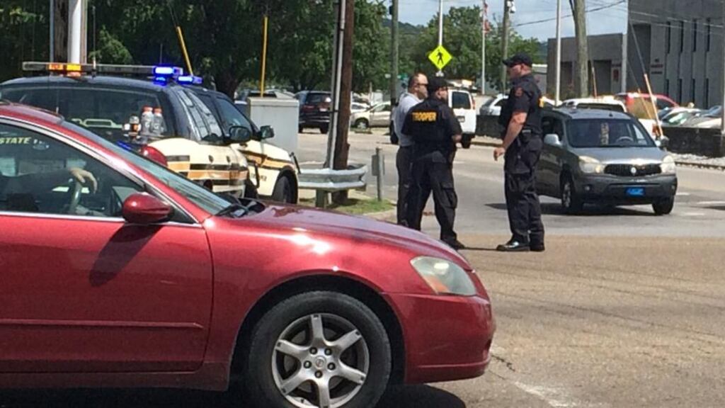 Police hold positions at a road block near the location where a gunman was shot by police on Amnicola highway in Chattanooga, Tennessee, on July 16th, 2015. Four Marines were killed in twin shootings at US military centres in the southern state of Tennessee, officials said. Photograph: Chole Morrison/AFP/Getty Images