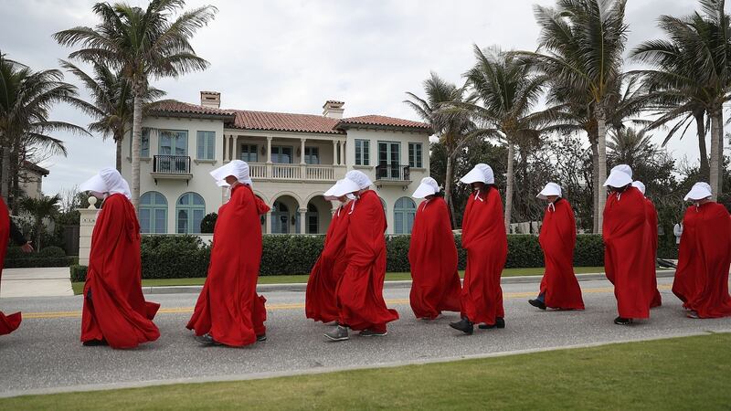 People dressed as handmaidens protest against president Donald Trump on the one year anniversary of his inauguration in Palm Beach, Florida. Photograph: Joe Raedle/Getty Images