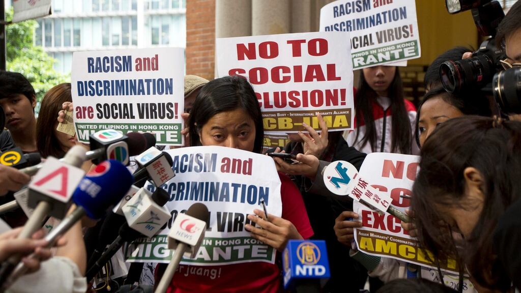 Indonesian Migrant Workers' Union chairperson Sringatin and other domestic helper groups hold banners during a protest outside the Court of Final Appeal in Hong Kong. Photograph: Tyrone Siu/Reuters