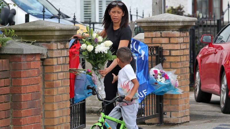 A neighbour places flowers this afternoon outside the home of innocent victim Trevor O’Neill who was murdered in Majorca two days ago Picture Colin Keegan, Collins Dublin.