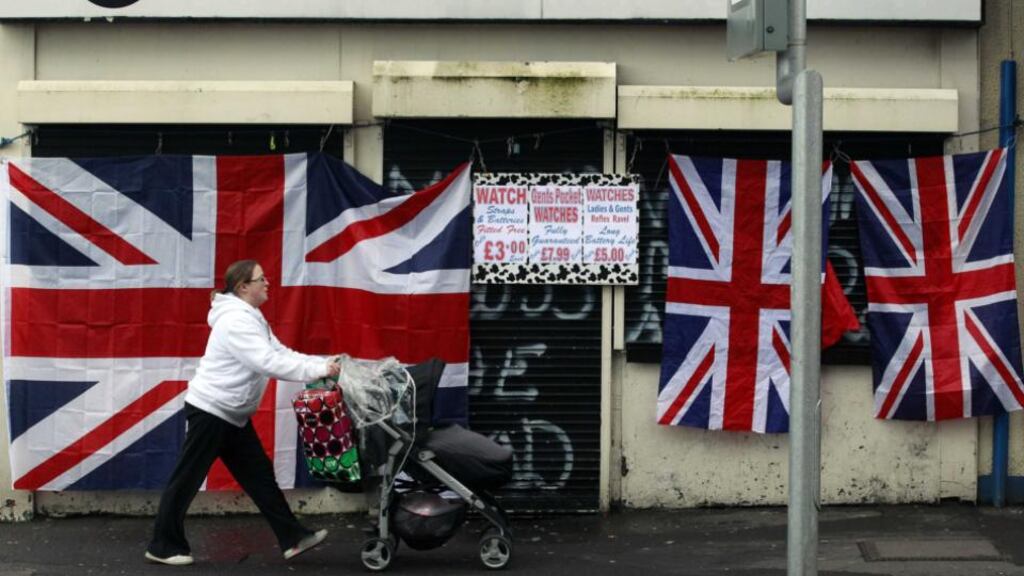 A woman walks past a union flag attached to a shuttered shopfront on the Shankill Road in west Belfast last December following violent protests over restrictions on flying the flag from Belfast City Hall. “If anyone is in any doubt about how conflict disrupts business, just ask Belfast’s hard-pressed merchants.” Photograph: Reuters