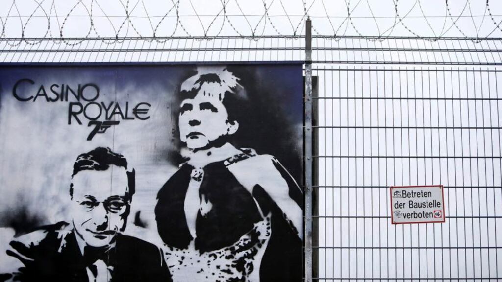 Graffiti depicting European Central Bank (ECB) president Mario Draghi and German chancellor Angela Merkel is seen on a fence surrounding the construction site for the new ECB headquarters in Frankfurt. The ECB held interest rates at 0.5 per cent today. Photograph: Ralph Orlowski/Reuters.