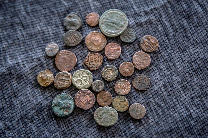 Coins collected by Abu Khaled are pictured at his home in Daraa, Syria. Photograph: Sally Hayden