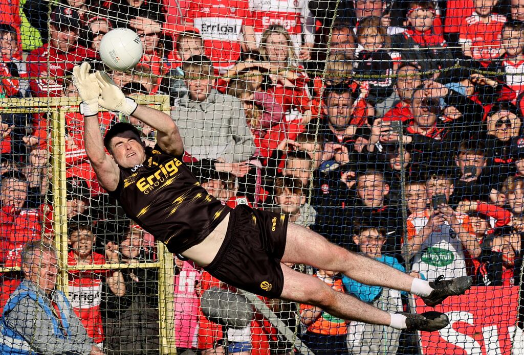 Odhran Lynch diving for three saves in the shoot-out, earning Derry a 3-1 win. Photograph: Tom Maher/INPHO