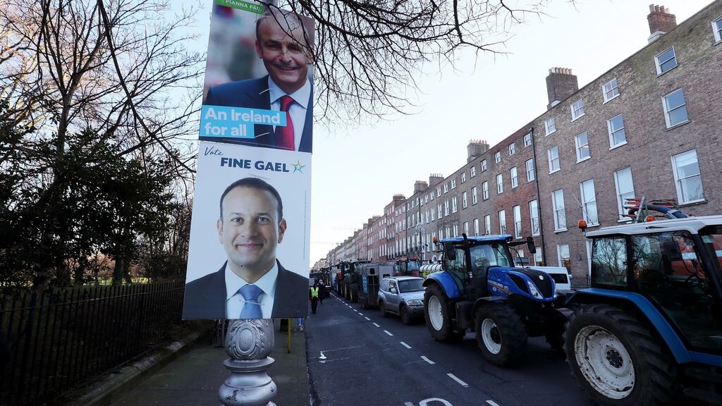 Election posters for Fianna Fáil’s Micheál Martin and Fine Gael’s  Leo Varadkar beside protesting farmers’ tractors in Dublin city centre last week. “With just under three weeks of campaigning yet to come, we can expect many election twists and turns before the winner is crowned, although it will take, in all probability, a while longer before a Government is formed.” Photograph: Brian Lawless/PA Wire