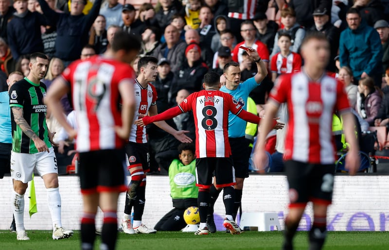 Sheffield United's Mason Holgate was shown a red card for a foul on Brighton's Kaoru Mitoma. Photograoh: Nigel French/PA Wire.