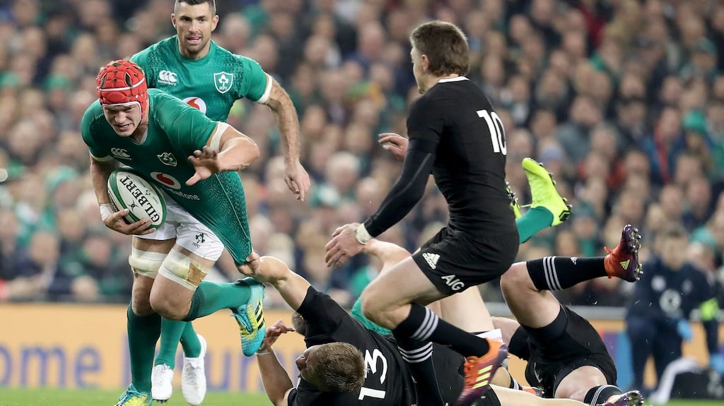 Ireland’s Josh van der Flier is dragged back by Beauden Barrett of New Zealand during the Guinness Series Test match at the Aviva Stadium in Dublin. Photo: Dan Sheridan/Inpho