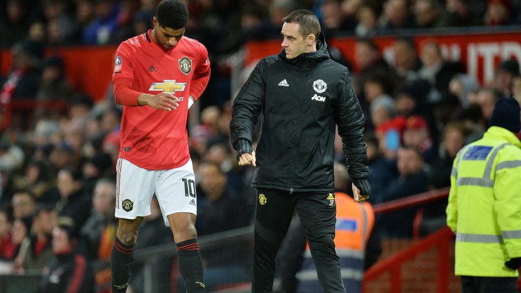 Marcus Rashford walks off injured during last night’s FA Cup third round replay at Old Trafford. Photograph: EPA