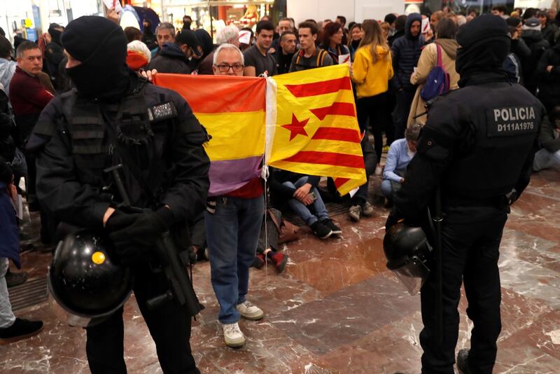 Mossos d’Esquadra and national police officers keep watch at the Sants station during the day of protests called by the Committees for the Defence of the Republic (CDR) under the motto ‘Total Blockade’, in Barcelona on Saturday. Photograph: Toni Albir/EPA