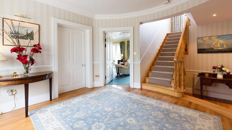 The house is opened up by handsome oak-floored circular entrance hall