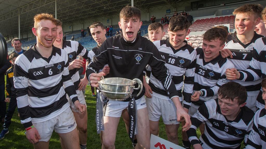 St. Kieran’s College’s Tom Witty celebrates with the Croke Cup trophy after it was damaged in the celebrations. Photo: Ryan Byrne/Inpho