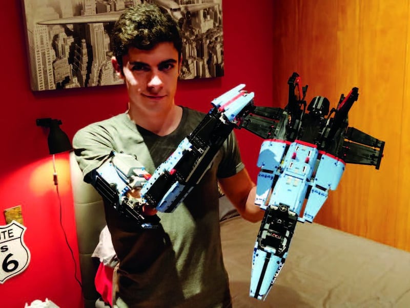 A teenage David Aguilar with Mk-II, the second prosthetic arm he built for himself, and the Lego Technic Air Race Jet that he used pieces from