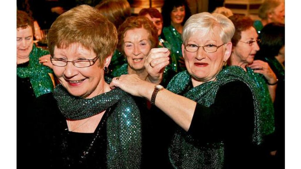 A safety pin saves the day as Kathleen Comerford helps Catherine Smith after a zip broke before a performance by the Irish Countrywomen's Association choir in St Patricks Hall, Dublin Castle, last night.