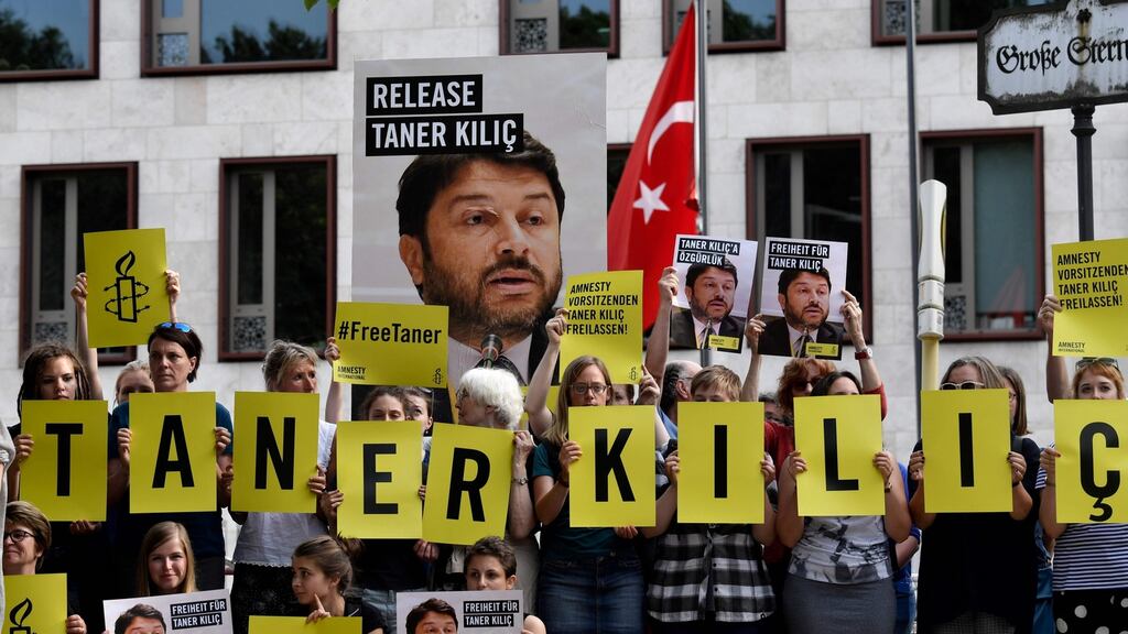 Amnesty activists protest against  detention of Taner Kilic. Photograph: AFP/ John Macdougall