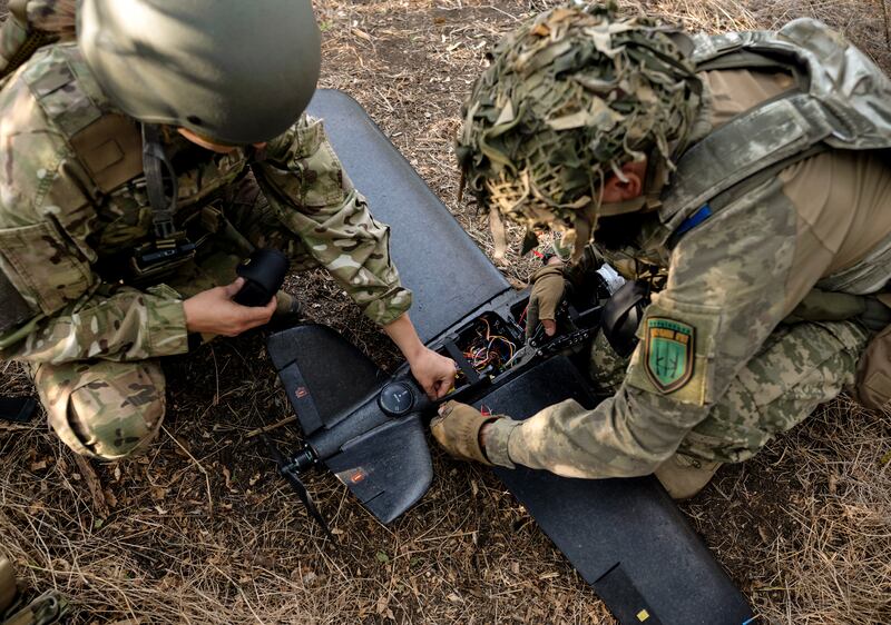 Members of the Ukrainian army prepare to fly a drone over Russian-occupied territory from a position in the Zaporizhzhia region. Photograph: Lynsey Addario/The New York Times