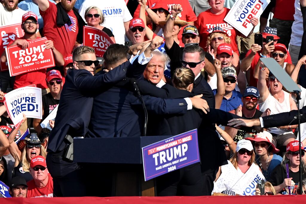 Former US president Donald Trump is surrounded by Secret Service agents during a campaign event in Butler, Pennsylvania, US, on Saturday. Trump is 'fine after a shooting incident where he was rushed off stage during rally his campaign said. Photograph: Joe Appel/Bloomberg