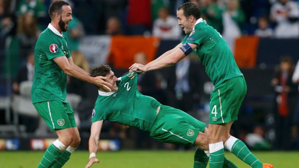 Ireland’s John O’Shea, Stephen Ward and Marc Wilson (right to left) celebrate after their Euro 2016 Group D qualification soccer match against Germany in Gelsenkirchen. Photograph: Wolfgang Rattay/Reuters