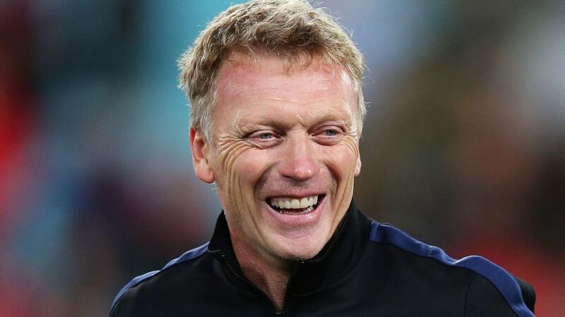 Manchester United manager David Moyes shares a joke with a coaching staff at full time. Photograph: Brendon Thorne/Getty Images