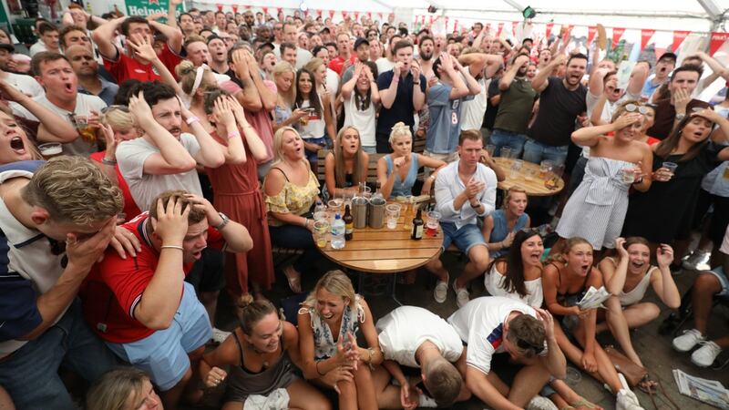 Fans react to a near miss at the Rose & Crown pub, in Wimbledon, south London. Photo: Philip Toscano/PA Wire