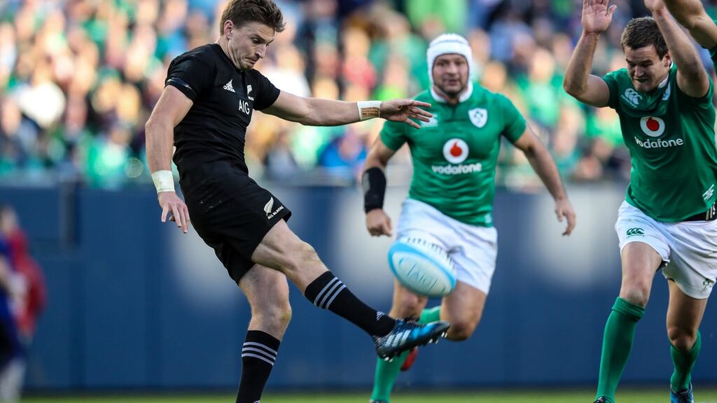 New Zealand clears the ball upfield against Ireland as Johnny Sexton rushes in. Photograph: Billy Stickland/Inpho