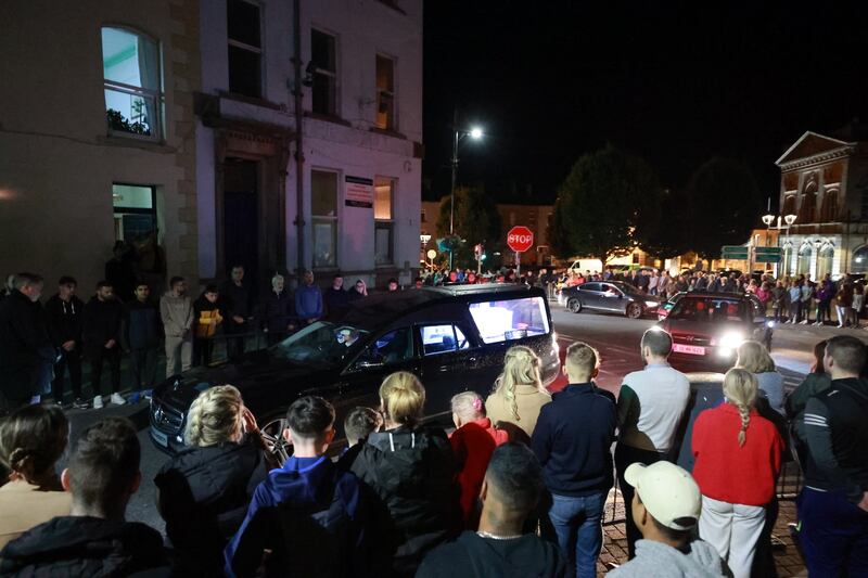 People form a guard of honour as the hearse carrying the remains of Kiea McCann arrives to the family home in Clones, Co Monaghan on Tuesday. Photograph: Liam McBurney/PA Wire