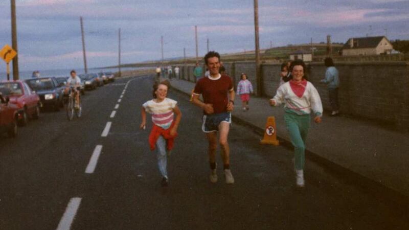 Maurice Mullins at the finish line of the first Iron Man Triathlon in Ireland which took place in Skerries (1987) with his daughters Deirdre and Maeve.