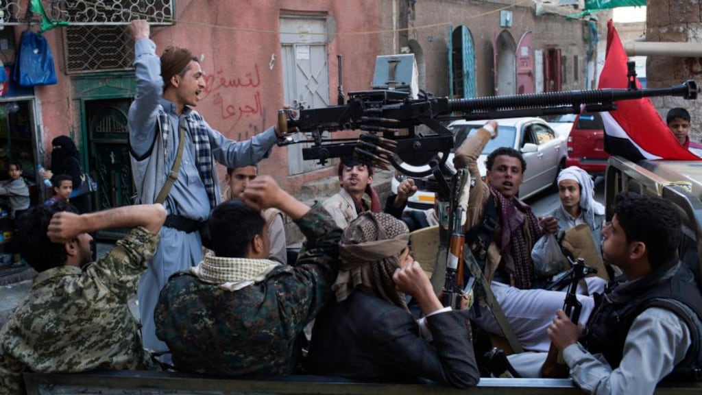 Men celebrate the Houthi’s intention to dissolve Yemen’s parliament. Photograph: Tyler Hicks/The New York Times