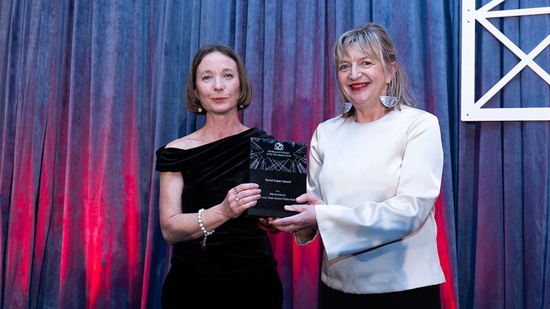 Collette Burns, architect, TU Dublin presents the social impact award to Máire Henry, DHB Architects