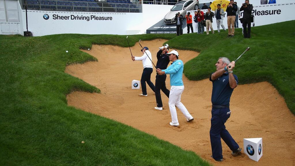 Justin Rose, Ian Poulter, Wu Ashun of China and Paul McGinley play from a bunker on the 18th hole prior to the BMW Masters at Lake Malaren Golf Club in Shanghai, China. Photo: Matthew Lewis/Getty