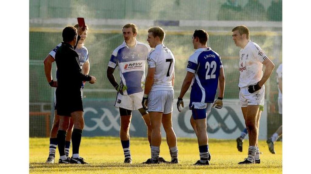 Referee Syl Doyle shows the red card to Kevin Meaney, Billy Sheehan and Peter O'Leary of Laois, and Morgan O'Flaherty and John Doyle of Kildare after a fight broke out between the teams in the O'Byrne Cup quarter-final at Portlaoise yesterday.