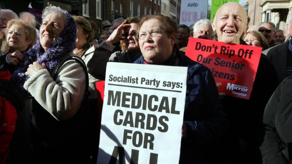 People taking part in a protest on medical cards for those aged 70 and over, outside Leinster House, yesterday. Photograph: Eric Luke