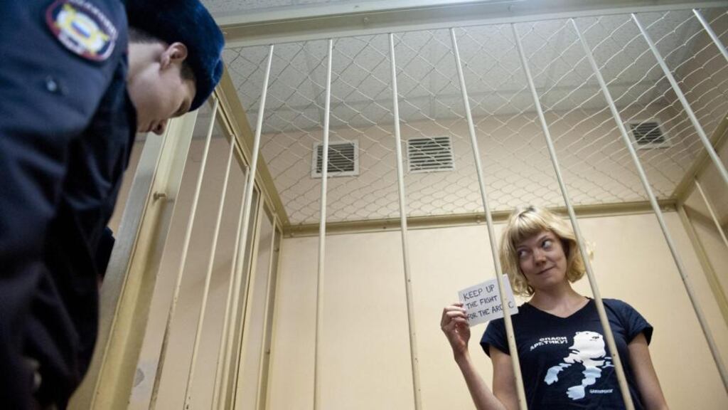 Greenpeace activist Sini Saarela of Finland stands in a cage before a court hearing at the Primorsky courthouse in St Petersburg, Russia. Photograph: Dmitri Shamrov/EPA/ Greenpeace International Handout