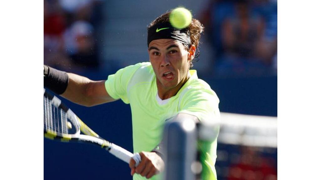 Rafael Nadal of Spain reaches for a return to Gilles Simon of France during the US Open tennis tournament in New York. - (Photograph: Kevin Lamarque/Reuters)