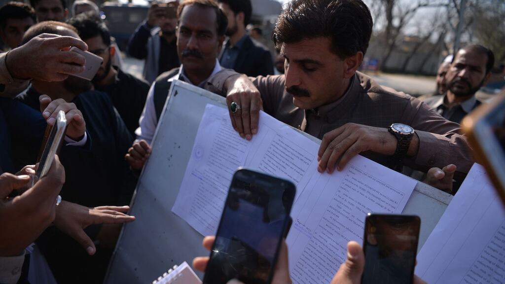 Pakistani local journalists take images of the court verdict against the suspects in the blasphemy lynching case outside the central jail in Haripur district. Photograph: Aamir Qureshi/AFP/Getty Images