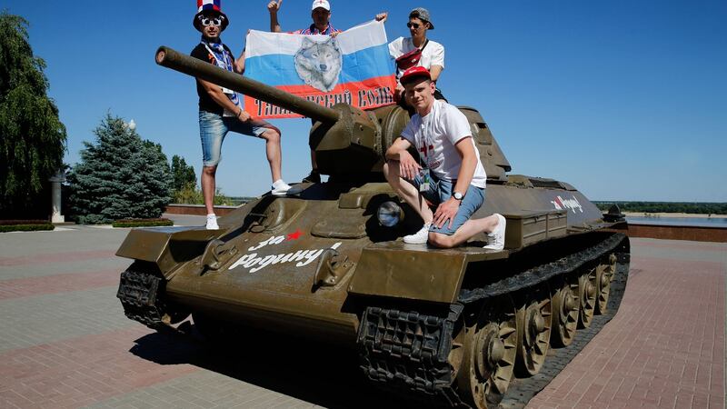 Russian fans pose on a T-34-76 tank near the Panorama Museum of the Battle of Stalingrad in Volgograd. Photograph:  Maxim Zmeyev/AFP/Getty Images