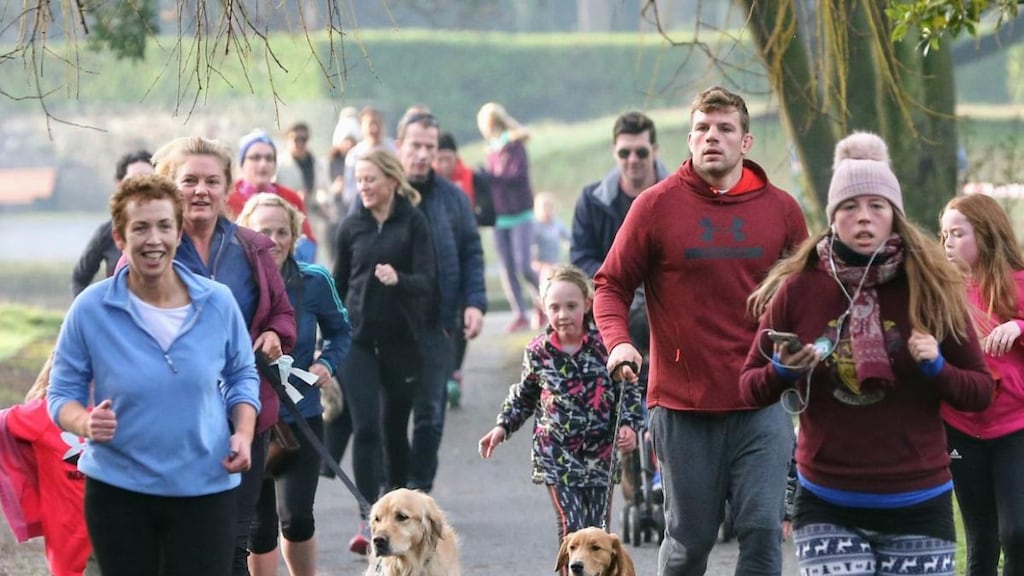 Jordi Murphy and his mother Nicola run the Goal Mile with their dogs at Herbert park in Dublin.
