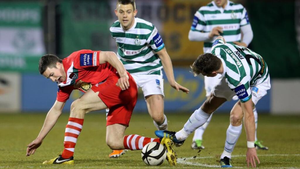 Shamrock Rovers's Ronan Finn tackles Gearoid Morrissey of Cork City at Tallaght Stadium. Photograph: Cathal Noonan/Inpho