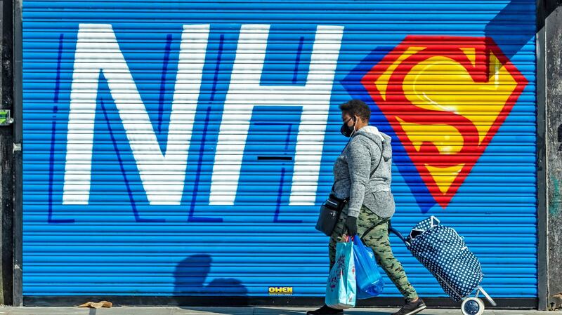 A person walks past a mural supporting the NHS in Kensington, Liverpool. Photograph: Peter Byrne/PA Wire