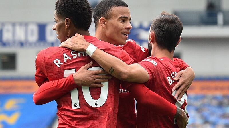 Mason Greenwood and Bruno Fernandes with Marcus Rashford after he gave Manchester United a 2-1 lead against Brighton. Photograph: Glyn Kirk/EPA